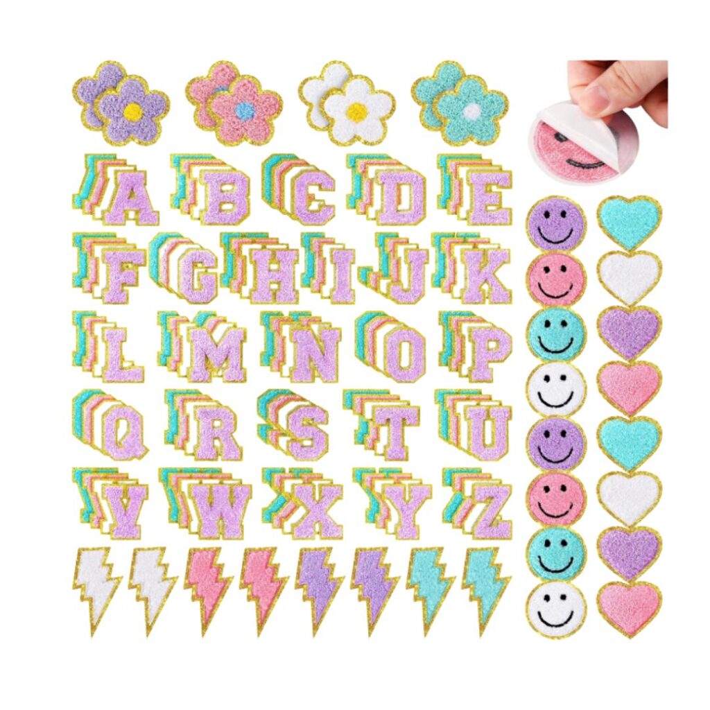 Colorful stickers with glittery gold borders—florals, alphabet letters (A-Z), smiley faces, hearts, and lightning bolts—make fun teen girl birthday party ideas. A hand peels a pink sticker in the upper right corner.