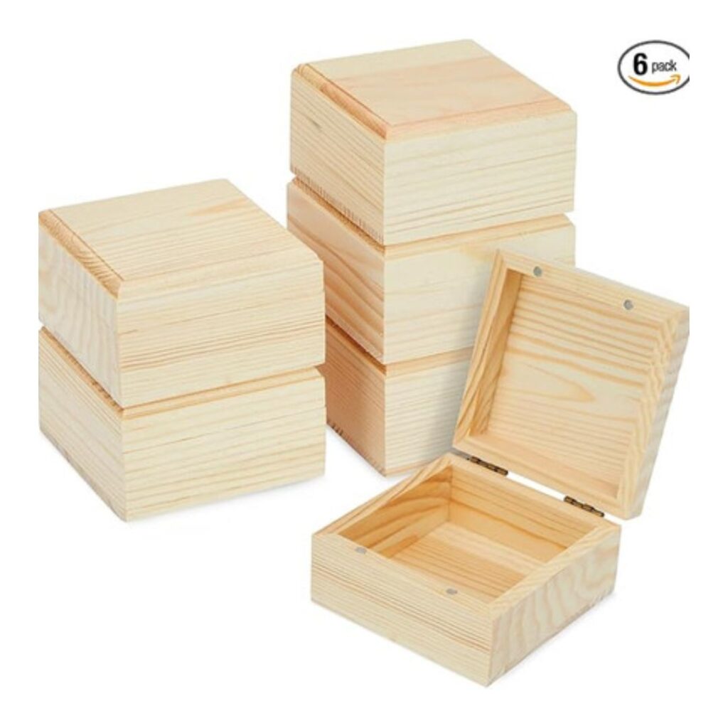 Six small, square, unfinished wooden boxes are shown—perfect for crafting activities and teen girl birthday party ideas. Five are stacked, with one open to display the interior. A "6 pack" label appears in the top right corner.