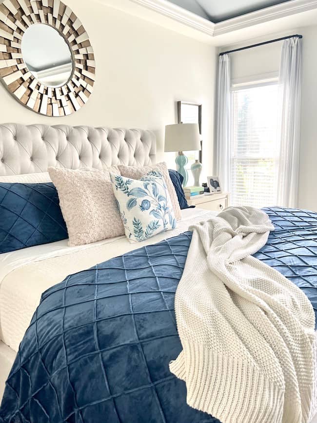 Layered bedding for fall with velvet duvet, quilts, plush pillows, and knitted throw