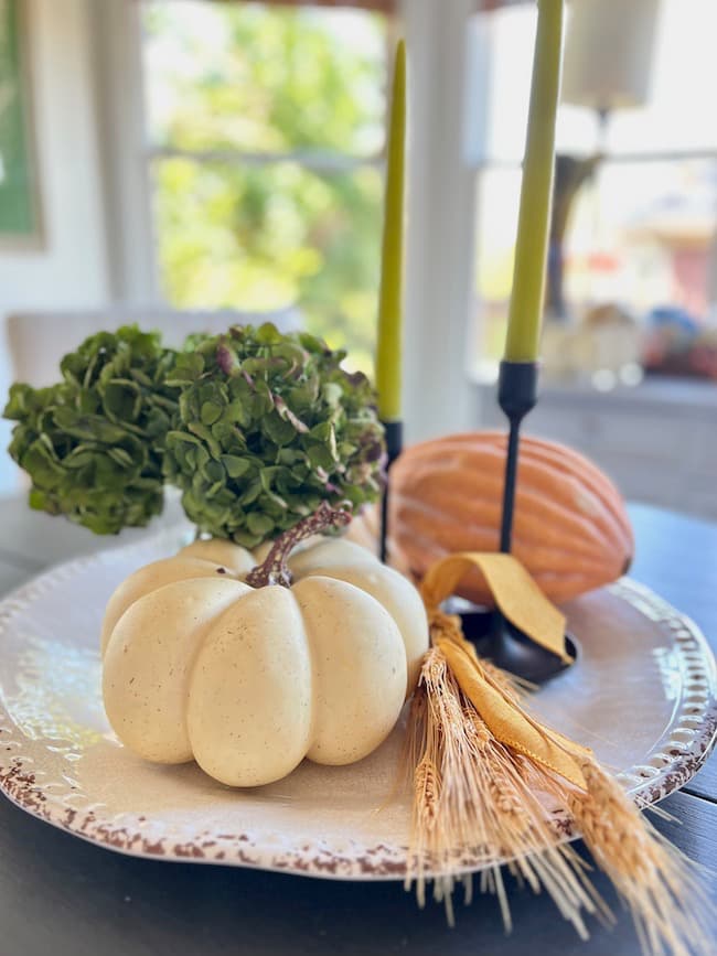 Simple Fall centerpiece with round tray, dried hydrangeas, and faux gourd.