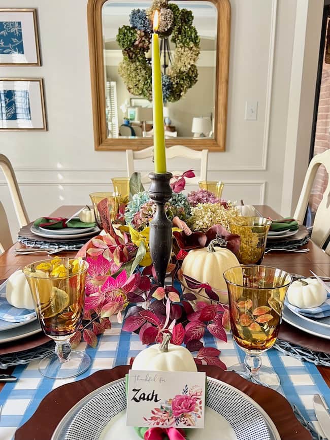 Thanksgiving Dinner Table centerpiece with dried hydrangeas, white pumpkins, fall stems, blue and white plaid paper table runner