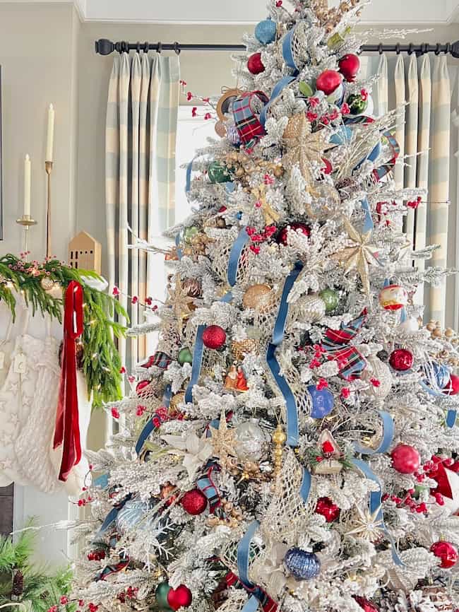 King of Christmas Queen flock tree with blue and red color scheme and glittered star ornaments.