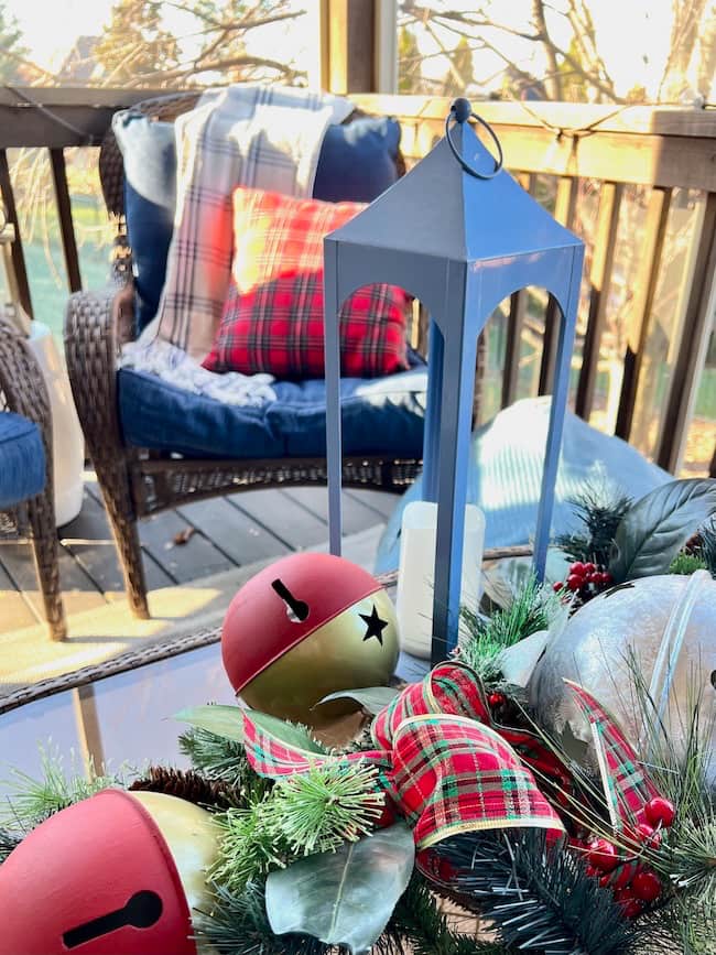 Screened porch Christmas decor with Tartan plaid and jingle bells.