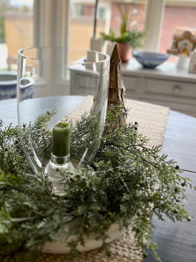 Simple greenery with hurricane vase for winter table