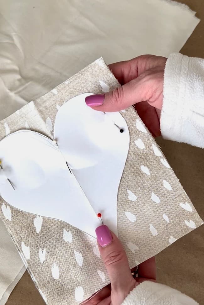 Pin the paper heart template to the antelope print fabric