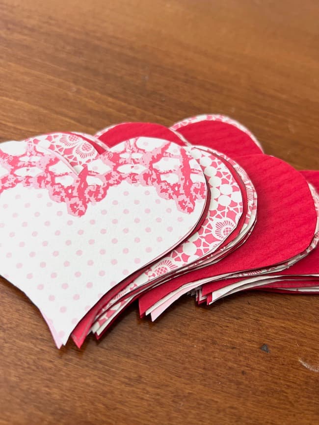 Pink and red paper hearts cut from card stock for Valentine's Day garland