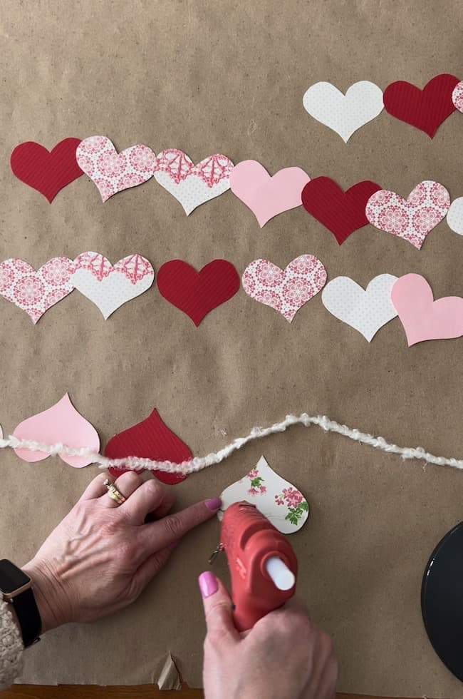 Glue the paper hearts to your yarn with hot glue.