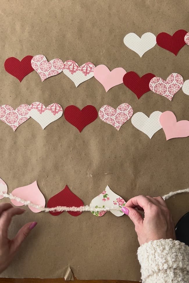 Glue the paper hearts to your yarn with hot glue.