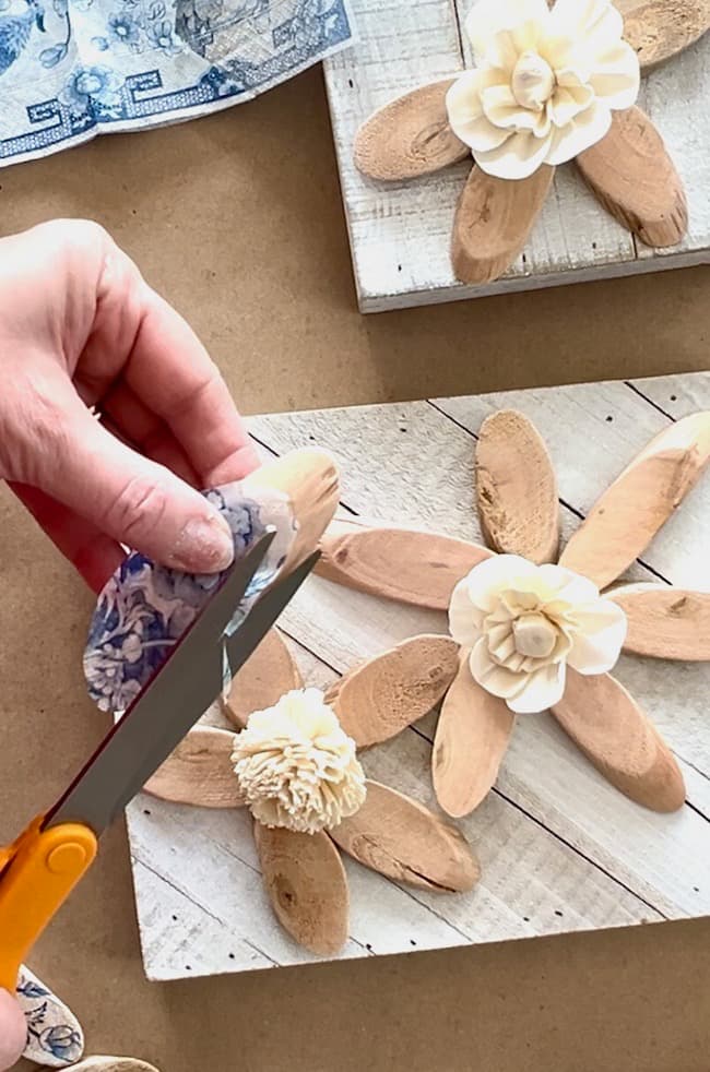 Trim the napkin pieces to fit the wood slices