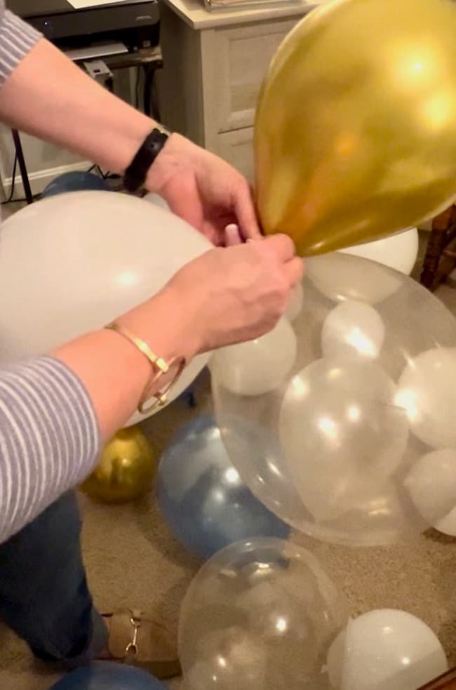 Tie balloons together to create a balloon garland.
