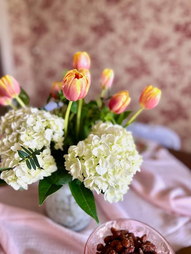 Bridal shower breakfast centerpieces with coral tulips and white hydrangeas