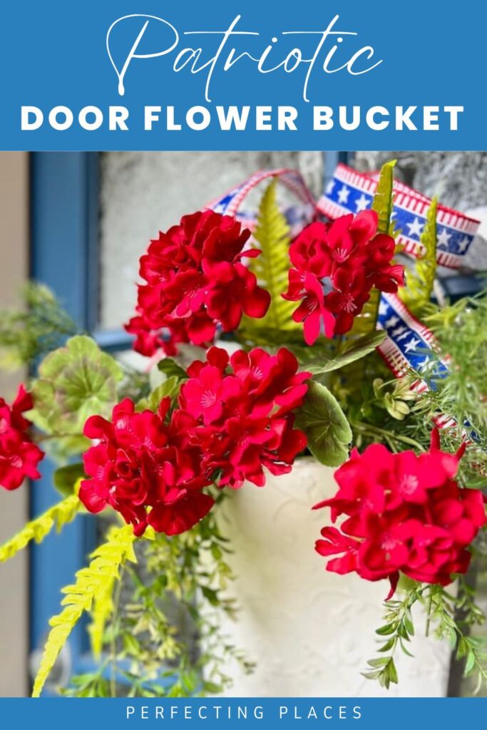Patriotic door decoration featuring a white metal flower bucket with red geraniums and patriotic ribbon PIN