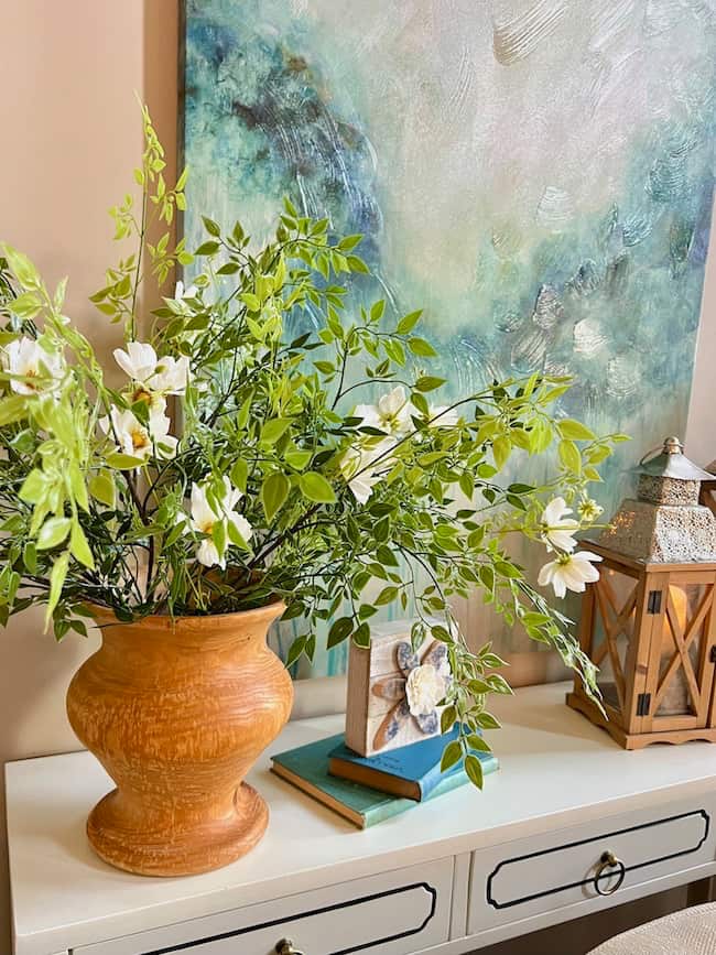 greenery and faux white cosmos in wooden vase