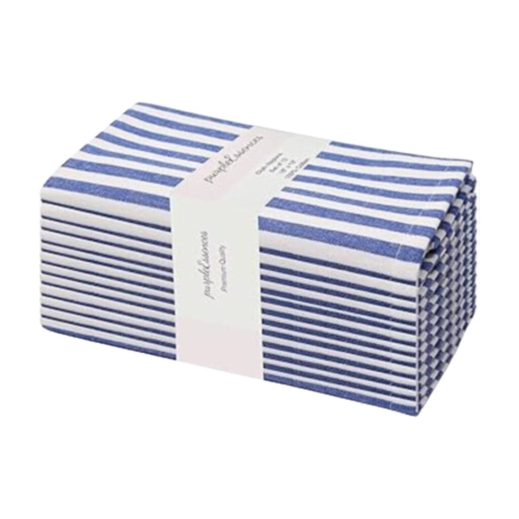 Stack of blue and white striped kitchen towels, neatly folded and wrapped with a white paper band that has "Purity Home" printed on it. Perfect to set a pretty summer table.