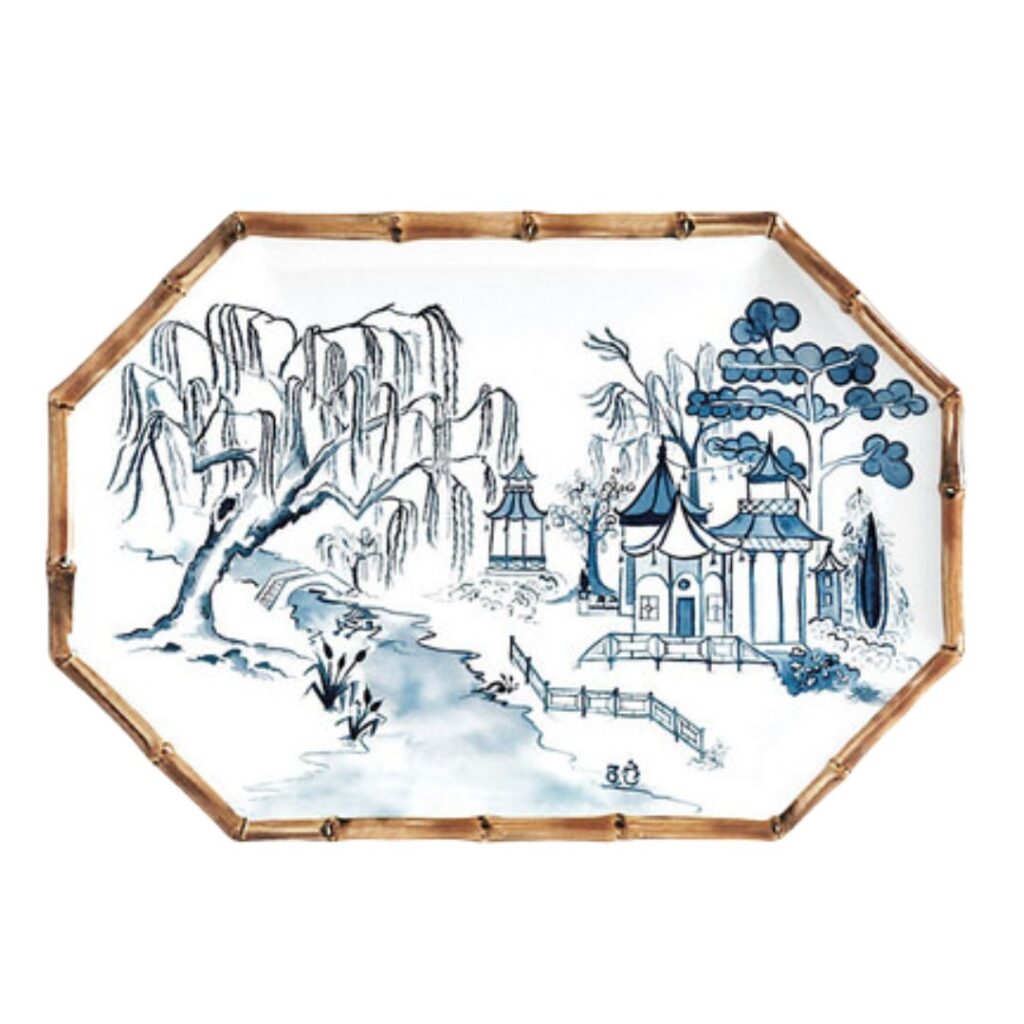 A rectangular tray with a bamboo-style rim, featuring a blue and white landscape design. The illustration includes a river, trees, and traditional Chinese buildings, evoking a serene, pastoral scene. Perfect to set a pretty summer table.