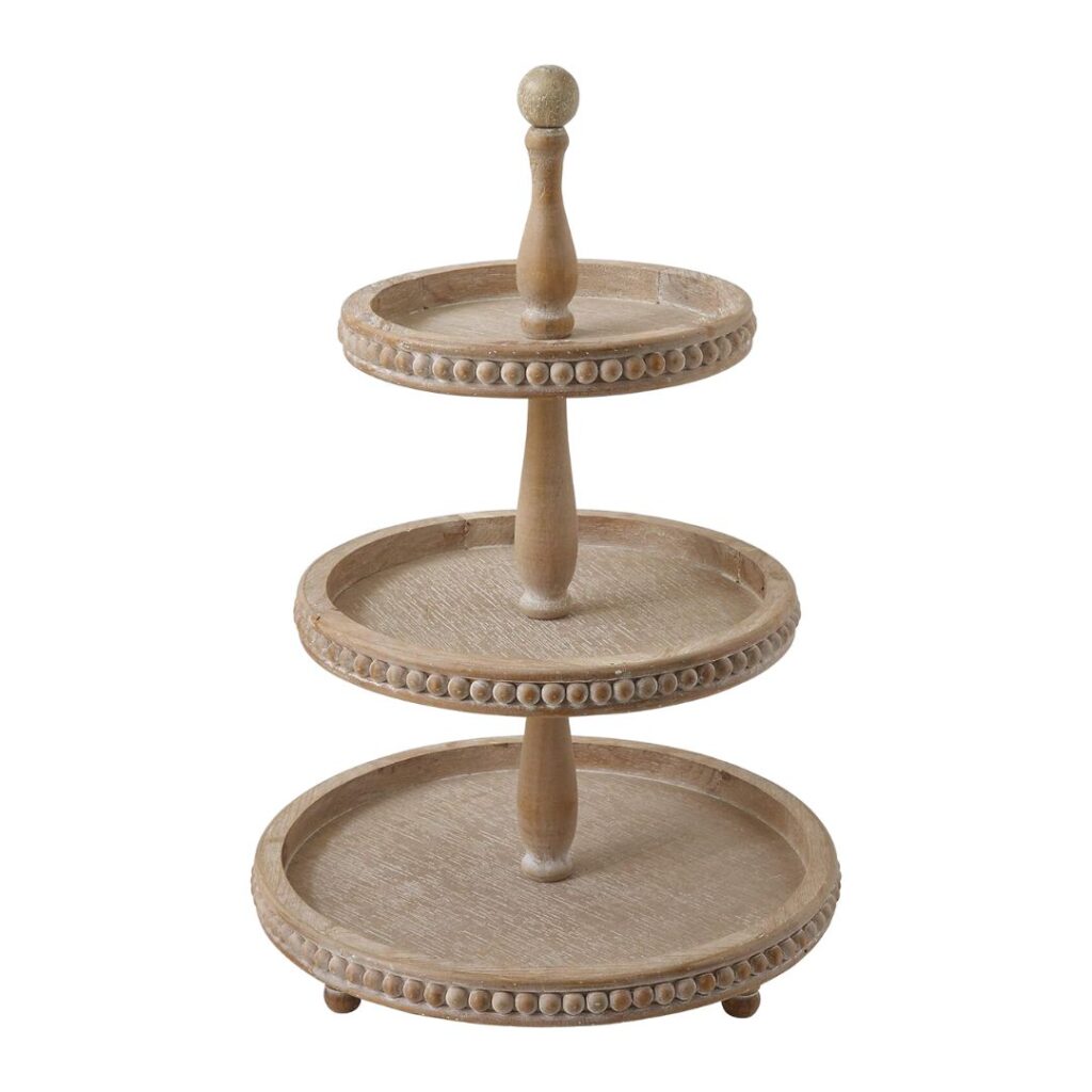 A three-tiered wooden tray stand with beaded edge detailing. Each tier is circular, supported by a central rod, and decreases in size from bottom to top. The stand is topped with a round finial and rests on small spherical feet, perfect to set a pretty summer table.