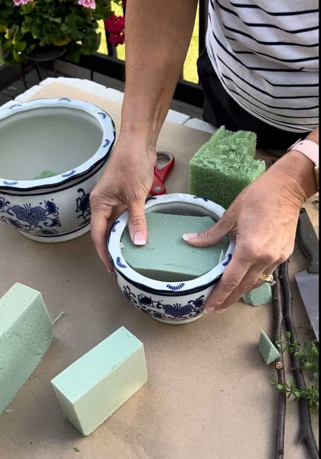 Cut the floral foam and insert into the pots