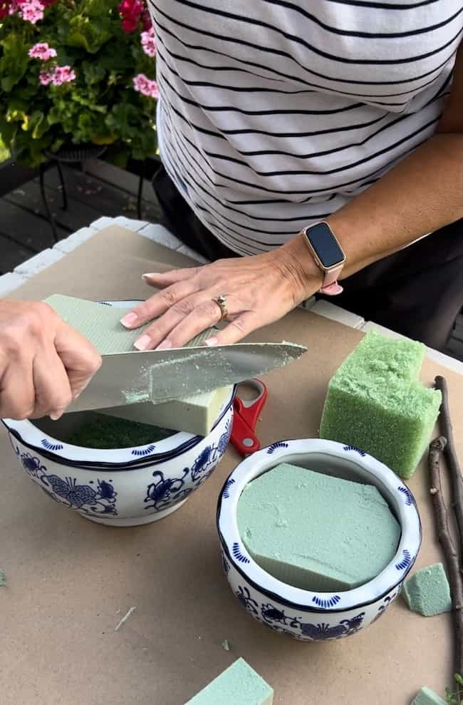 Cut the floral foam to fit the pots