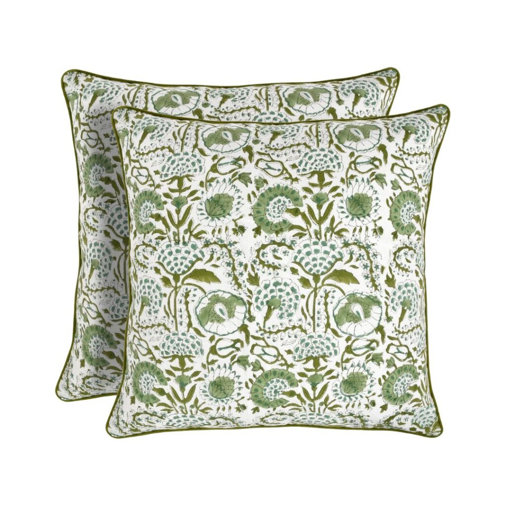 Two square decorative Block Print pillows featuring a green and white floral pattern with intricate details are available on Amazon. The edges are outlined with a green trim. These budget-friendly pillows overlap slightly, showcasing their elegant design.