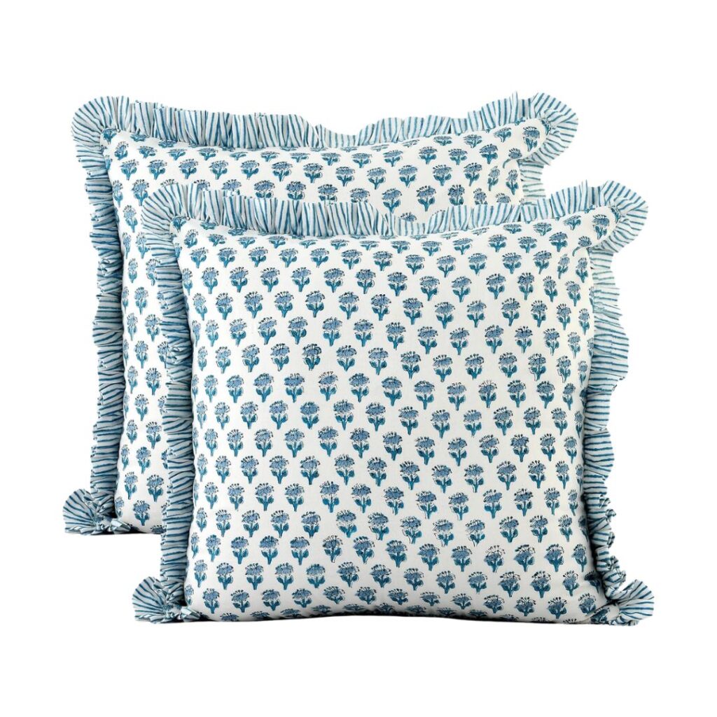 Two decorative, budget-friendly pillows with a white background and blue floral pattern. Each pillow features a ruffled edge with blue and white stripes. The square pillows are arranged at a slight angle, overlapping each other, making an elegant addition to your Amazon home décor collection.