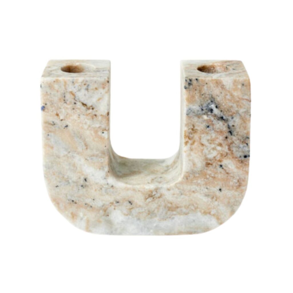 A U-shaped marble candle holder with a polished finish, displaying a mix of beige, brown, and grey veining. The holder has two circular recesses for candles on the top ends of the "U.