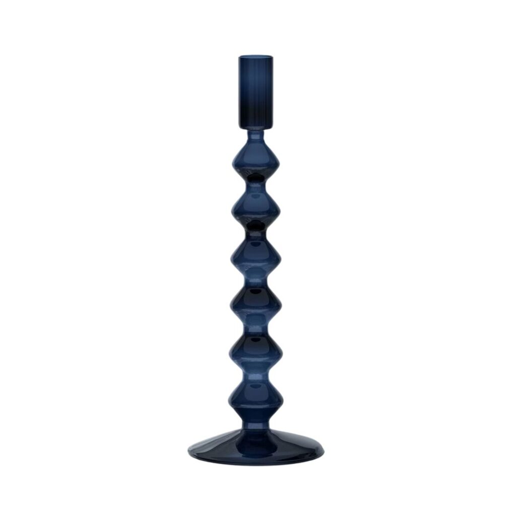 A tall, dark blue glass candle holder with a wavy, geometric design along its stem, tapering into a flat base. The holder is empty, showcasing its sleek and modern aesthetic.