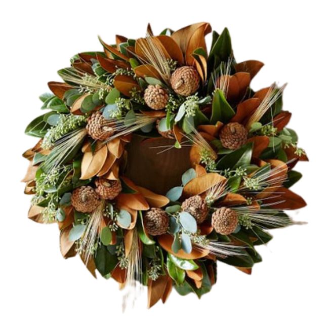 A decorative wreath made of various green and brown leaves, accented with small beige flowers and clusters of seed pods, arranged in a circular pattern. The wreath has a natural, rustic appearance, suitable for autumn or holiday decoration.