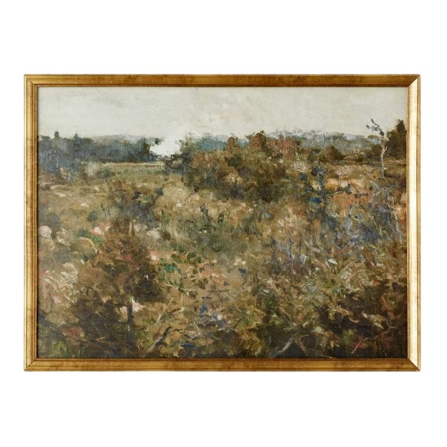 A landscape painting depicts a serene, rustic scene with tall grasses and wild foliage in the foreground, transitioning to a hazy, distant tree line. The muted palette and soft brushstrokes evoke a sense of tranquility. The artwork is framed in a golden wooden frame.