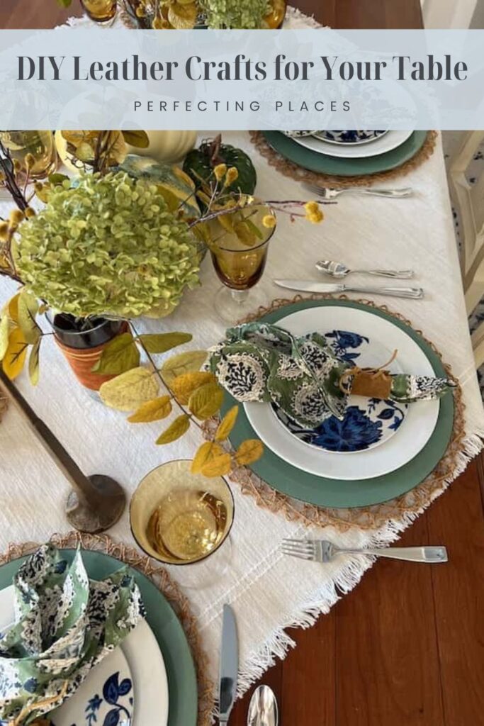 A table setting with plates on woven placemats, green and white floral napkins, and yellow glasses becomes an autumn masterpiece. A decorative centerpiece with green and yellow foliage complements the DIY leather fall table decor. Text overlay reads, "DIY Leather Crafts for Your Table - Perfecting Places.