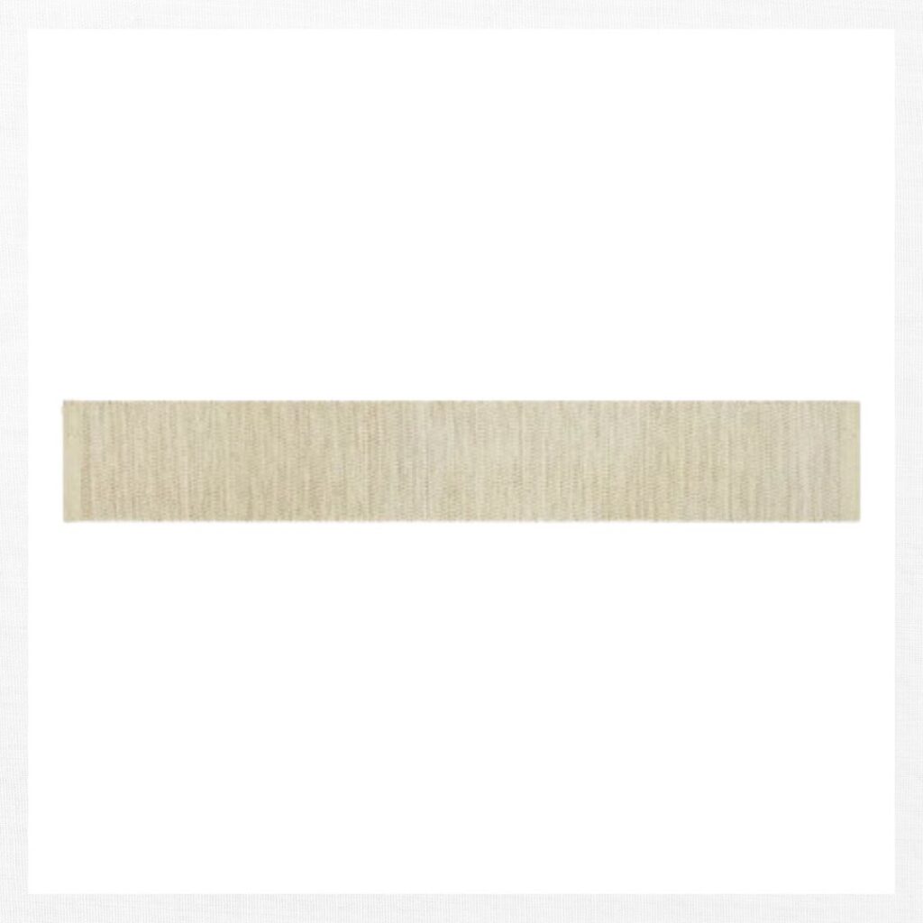 A wide, horizontal strip of beige woven fabric is centered on a plain white background—perfect for inspiring fall kitchen decor ideas on a budget.