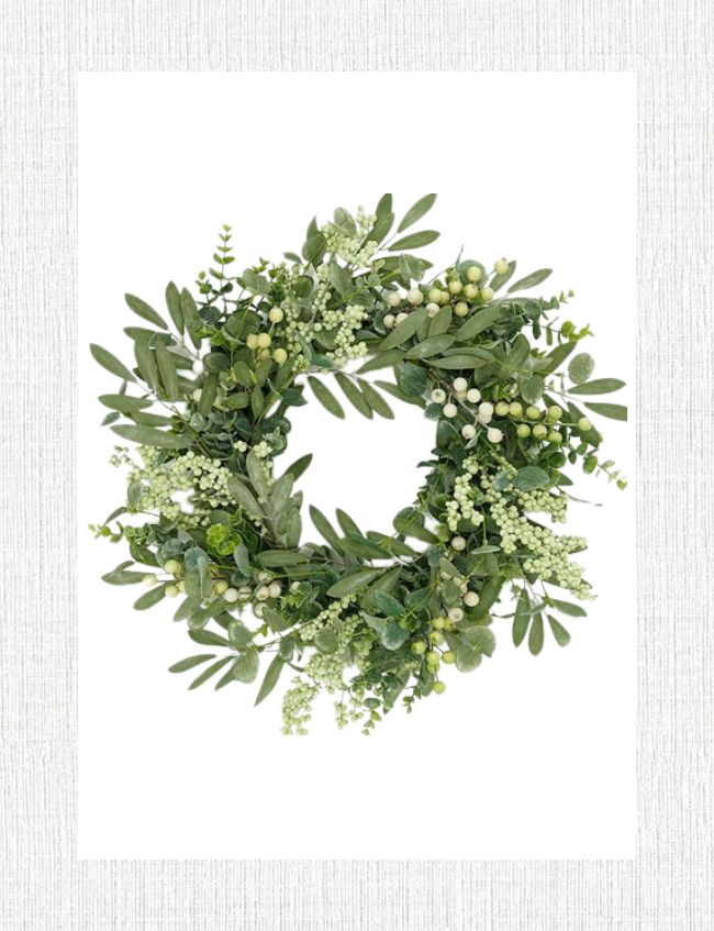 A green wreath adorned with assorted leaves and small white berries graces the foyer, set against a textured, light gray background. Perfect as entryway decor to welcome the freshness of spring.