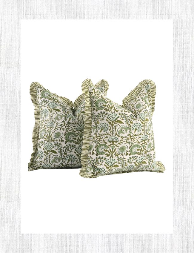 Two decorative pillows featuring a trendy green floral pattern on a white background add charm to any spring entryway. The pillows are edged with green and white striped ruffles, set gracefully against a plain, light-textured backdrop. Perfect for uplifting foyer decor.