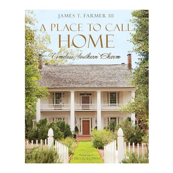 Book cover of "A Place to Call Home: Timeless Southern Charm" by James T. Farmer III, featuring a white two-story Southern-style house with columns, greenery, and a white picket fence—a perfect guide for learning how to decorate a footed bowl with Southern flair.