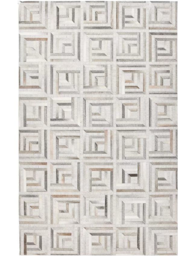 A rectangular neutral textured area rug featuring a geometric pattern of repeating squares and rectangles in varying shades of gray, beige, and white, creating a striking three-dimensional, optical illusion effect.