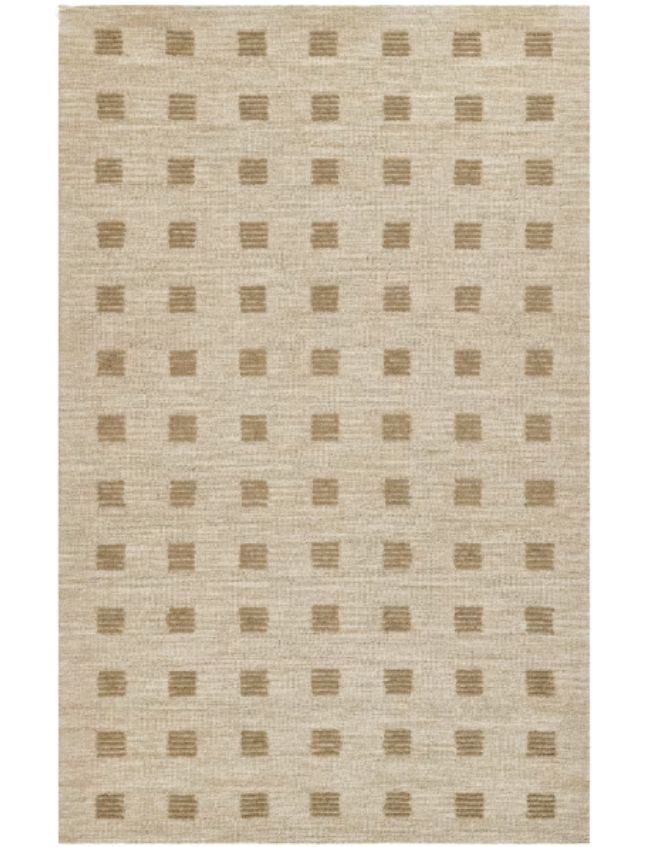 A beige area rug with a subtle pattern of evenly spaced, small, rectangular tan blocks arranged in a grid across the surface—perfect for those seeking neutral textured area rugs.