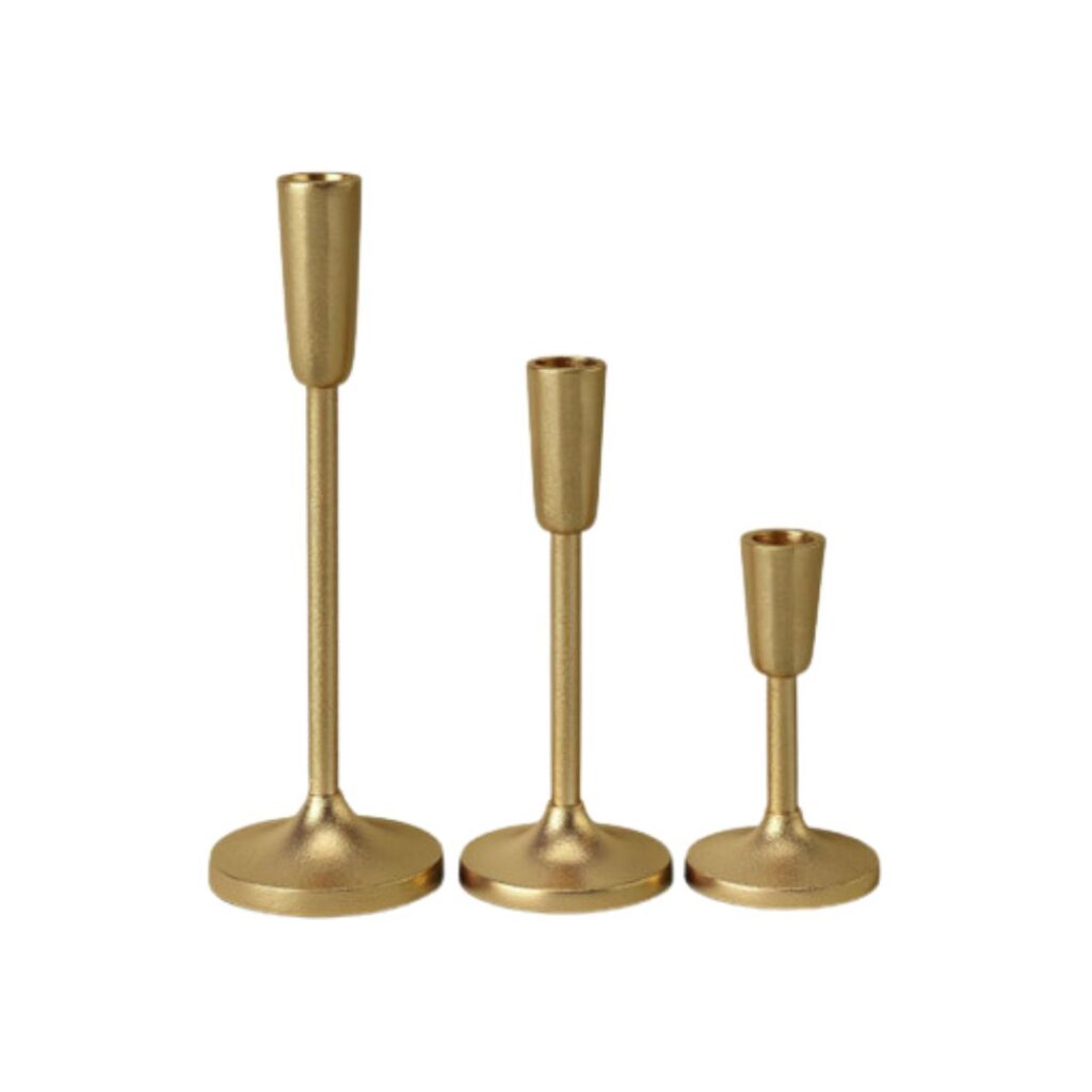 Three gold metal candle holders of varying heights are arranged side by side on a white background. The holders have a sleek, modern design with round bases and cylindrical stems.