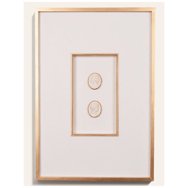 A minimalistic framed artwork features two small, oval, white cameo portraits with gold borders—reminiscent of DIY intaglio art—centered within a white mat and surrounded by a thin gold frame.