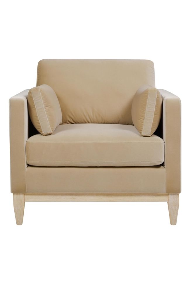 A beige armchair with wooden legs, square armrests, and two cylindrical accent pillows adds timeless comfort to any living room, viewed from the front against a white background.