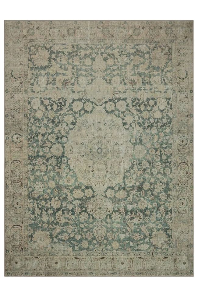 An ornate, vintage-style area rug with a detailed floral and medallion pattern in muted shades of blue, gray, and beige accents. Its intricate central motif and decorative border make it perfect for elevating any living room décor.