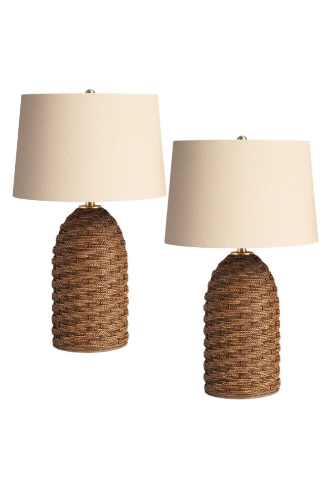Two table lamps with cream-colored drum shades and brown woven bases, perfect for adding green and beige accents to a timeless living room. Placed side by side against a white background.