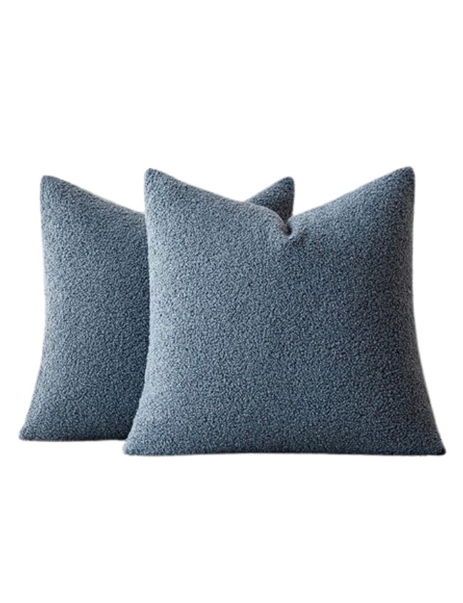 Two blue textured square throw pillows are placed overlapping each other on a plain white background, perfect for adding a touch of classic cozy living room decor to your space.