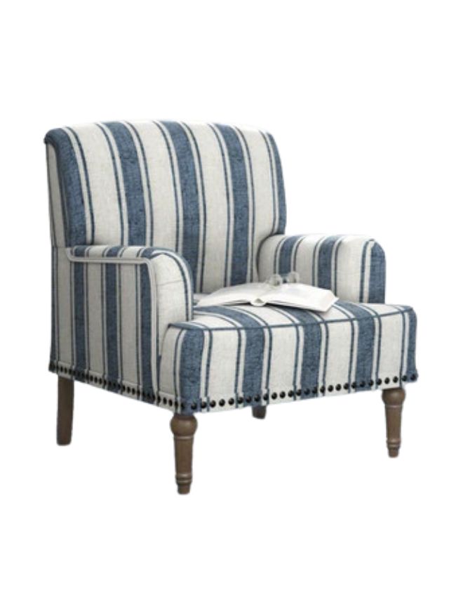 A cushioned armchair with blue and white vertical stripes, wooden legs, and decorative trim—perfect for classic cozy living room decor. An open book and a pair of glasses rest on the seat. The chair is isolated on a white background.