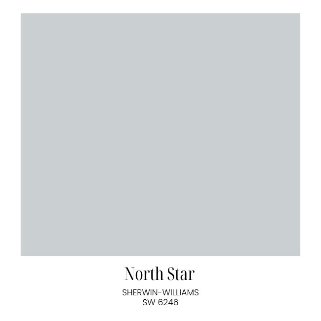 A paint swatch showing a soft, light gray-blue color labeled "North Star" by Sherwin-Williams, SW 6246. The label appears below a square sample of the paint color—perfect for classic cozy living room decor.